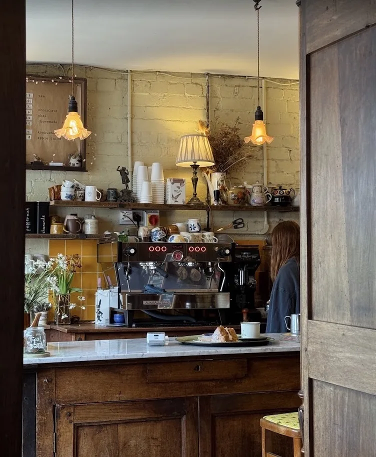 Espresso machine and barista behind the Wardrobe counter