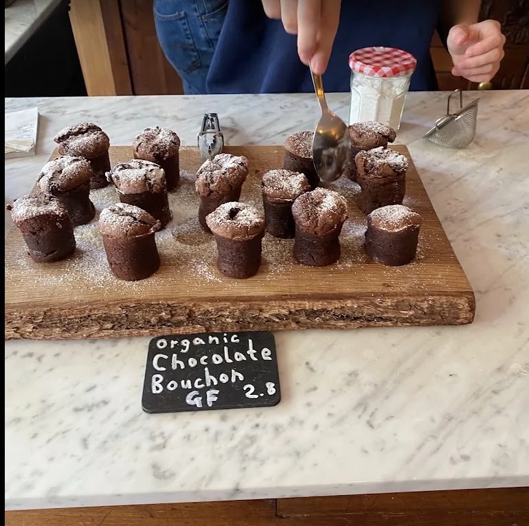 Chocolate bouchons displayed with a handwritten counter label