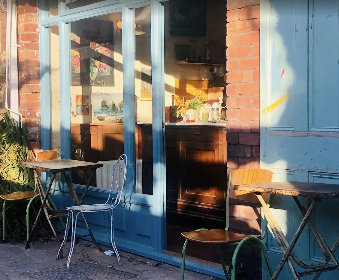 Blue-fronted exterior seating at The Wardrobe Coffee Shop