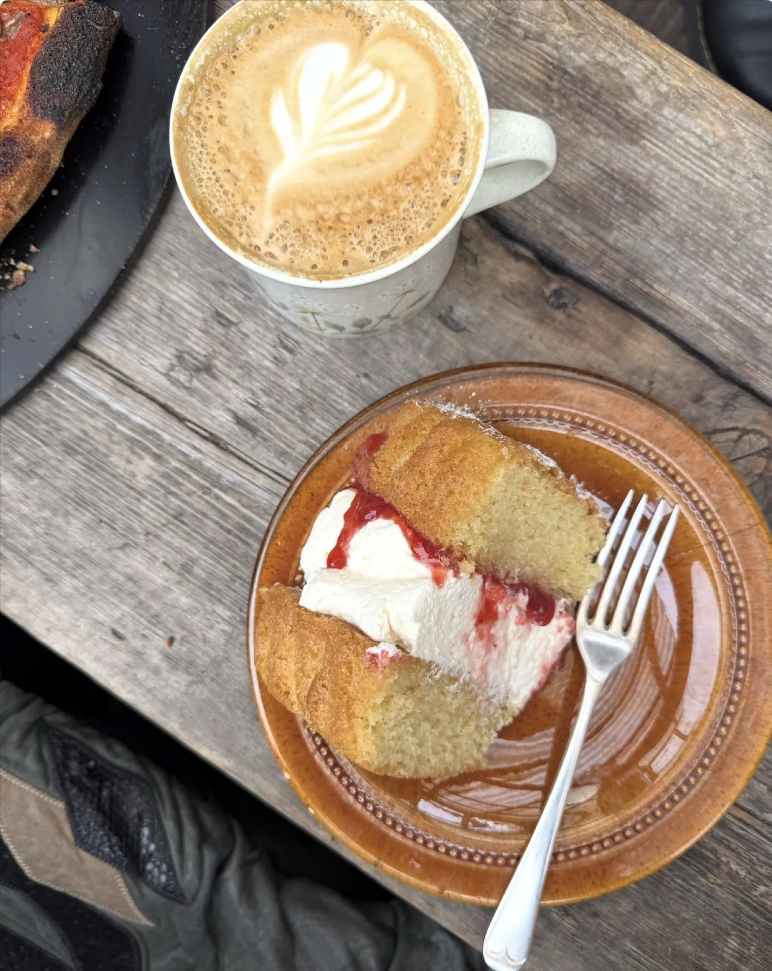 Latte and sponge slice on the yard table