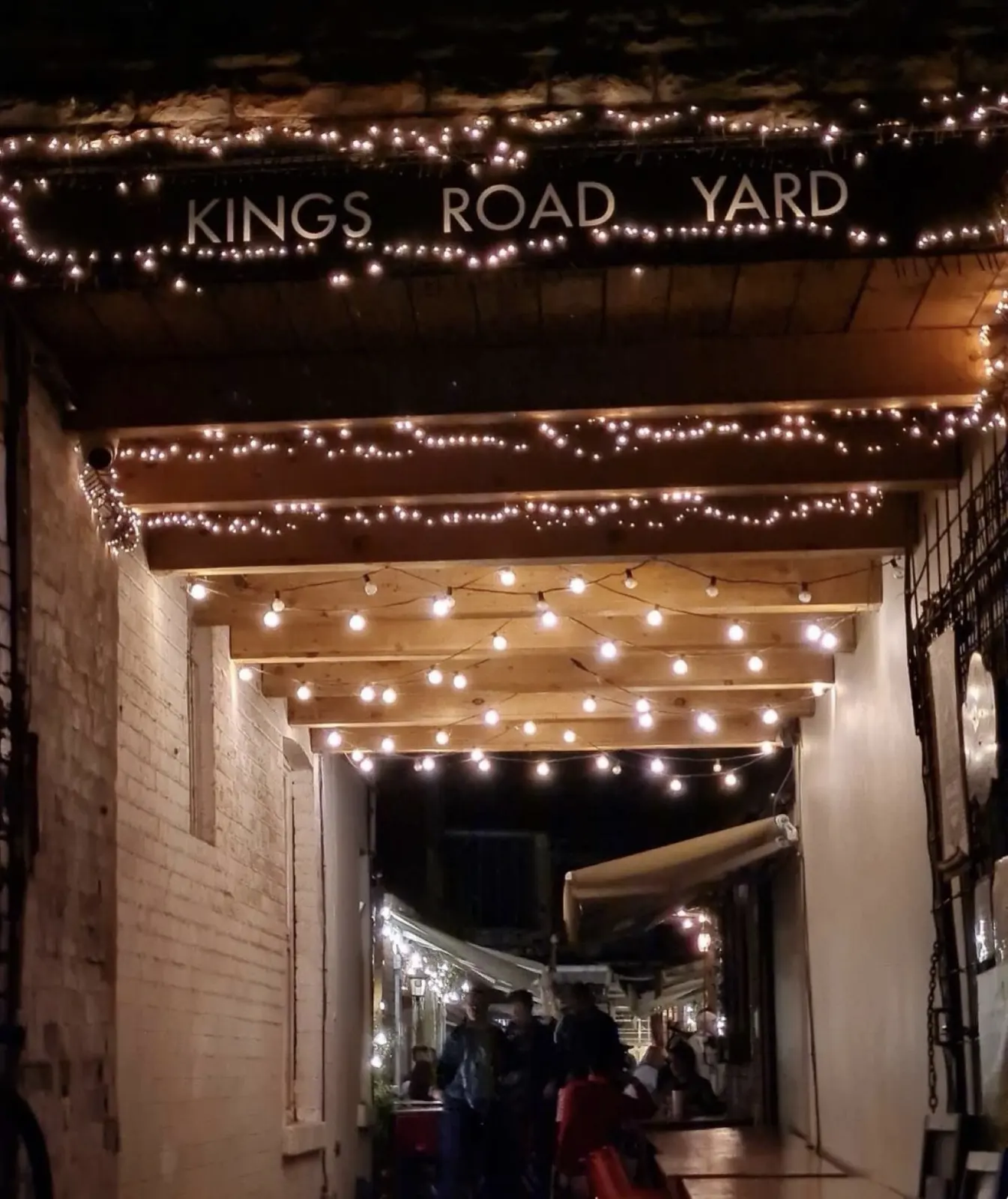 Kings Road Yard entrance at night with fairy lights